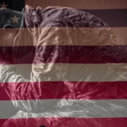 Image of a veteran with an American flag faded in